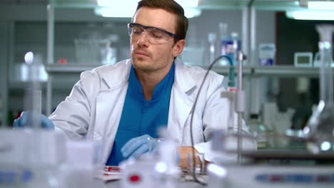 Scientist-in-lab.-Scientist-looking-at-chemical-liquid-in-research-laboratory